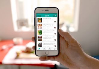 A person holding a phone showing the Olio food sharing app