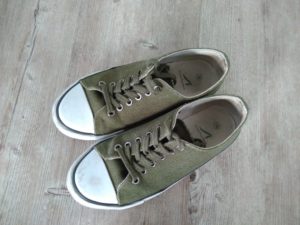 a pair of canvas lace up shoes in green