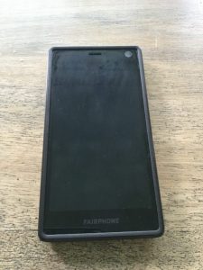 A Fairphone on a wooden background
