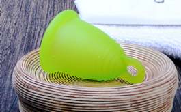 Green menstrual cup brand "Luna Cup".