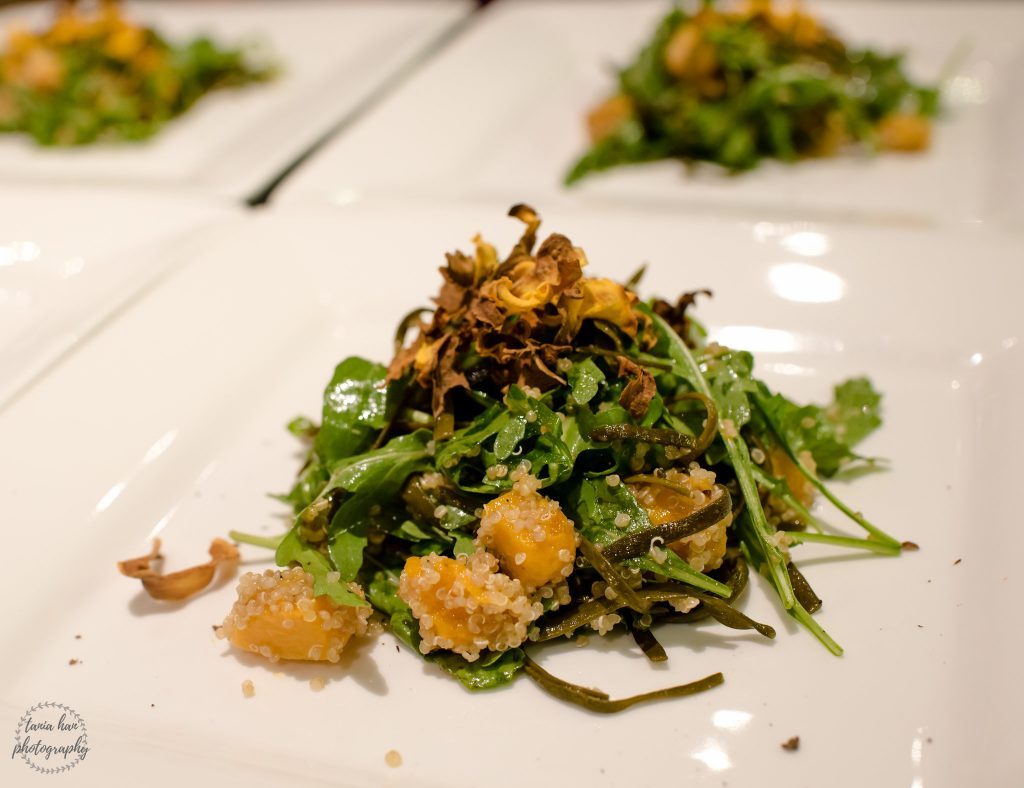 Vegetarian starter; Salad leaves, butternut squash cubes and seaweed on large white plate