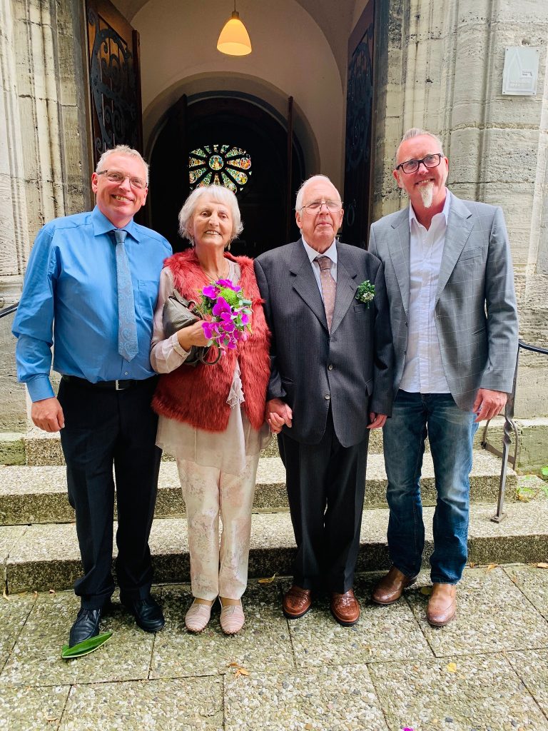 Group of four people stood outside a church