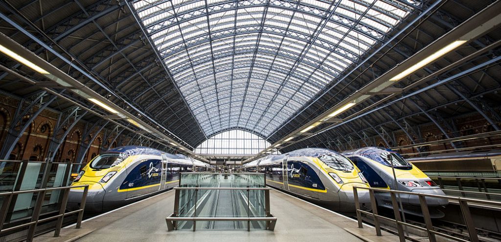 St Pancras station from the Eurostar platform. Three trains seen from the front.