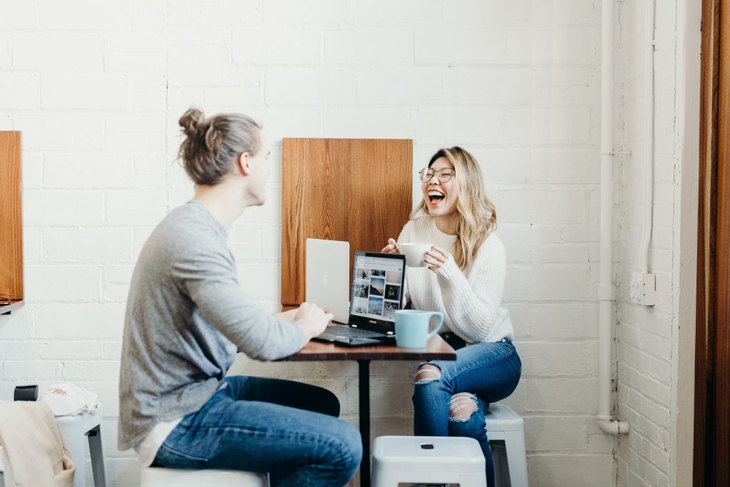 Couple sitting at desk with laptops. Reviewing intentions.