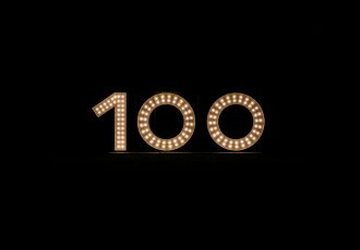 Number 100 in lights on a black background