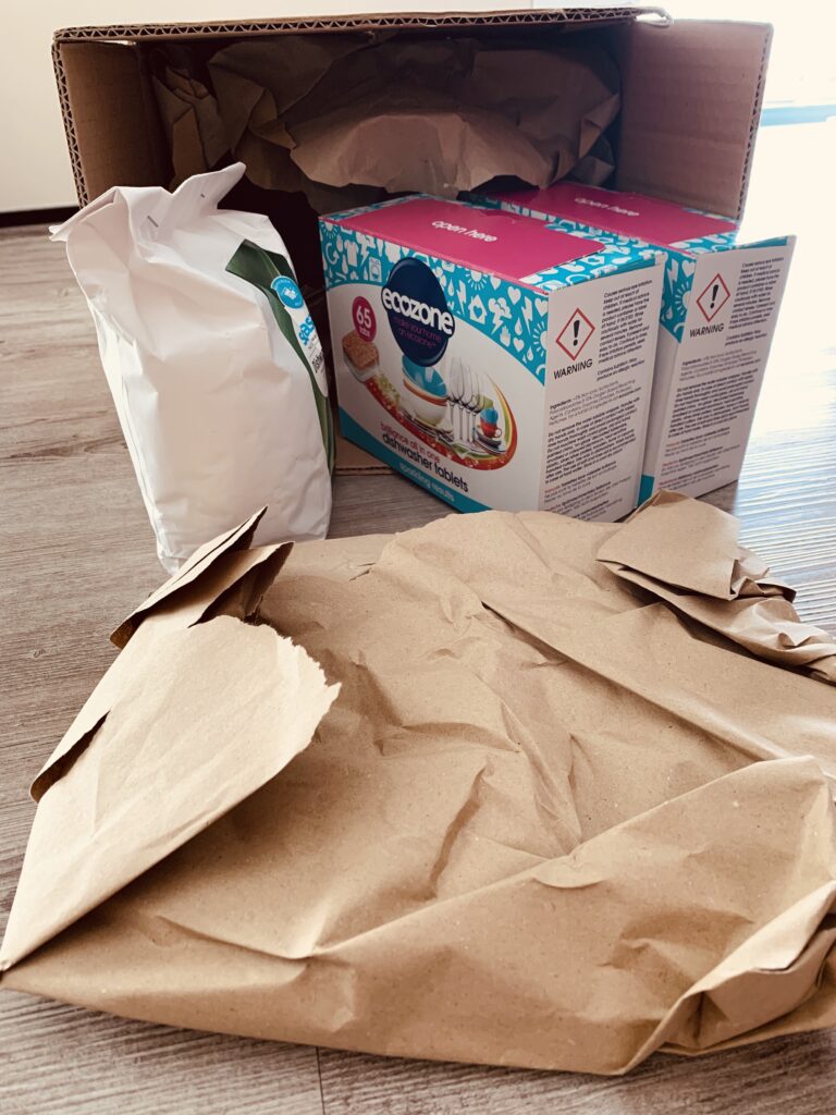 A cardboard box with paper packing material.