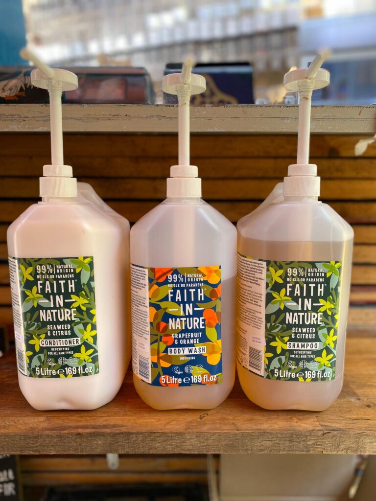 Three 5 litre containers of toiletries with pump dispensers.