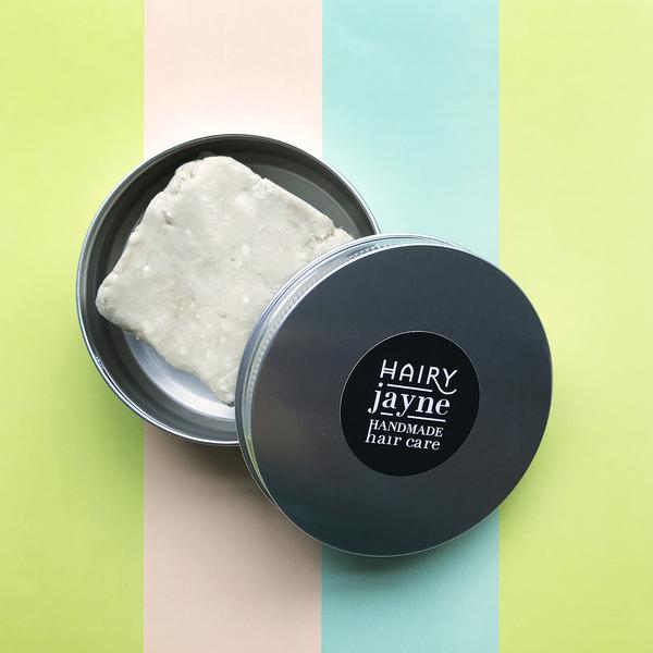 A shampoo bar in a metal tin