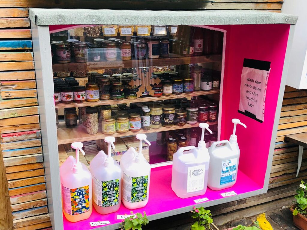 A shop window sill with a number of pump dispensers. Including one for shampoo