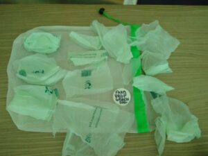 Home compostable bag cut up on top of net bag.