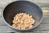 Many corks in the bottom of a black planter