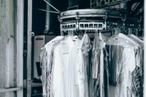 Garments hanging in plastic covers on a rail